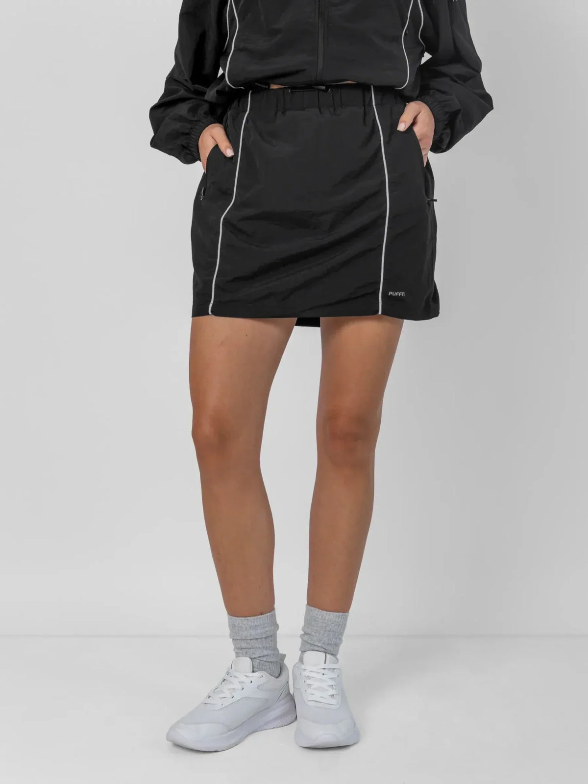 PUFFLT water repellent regular fit track skirt in black with white trim.